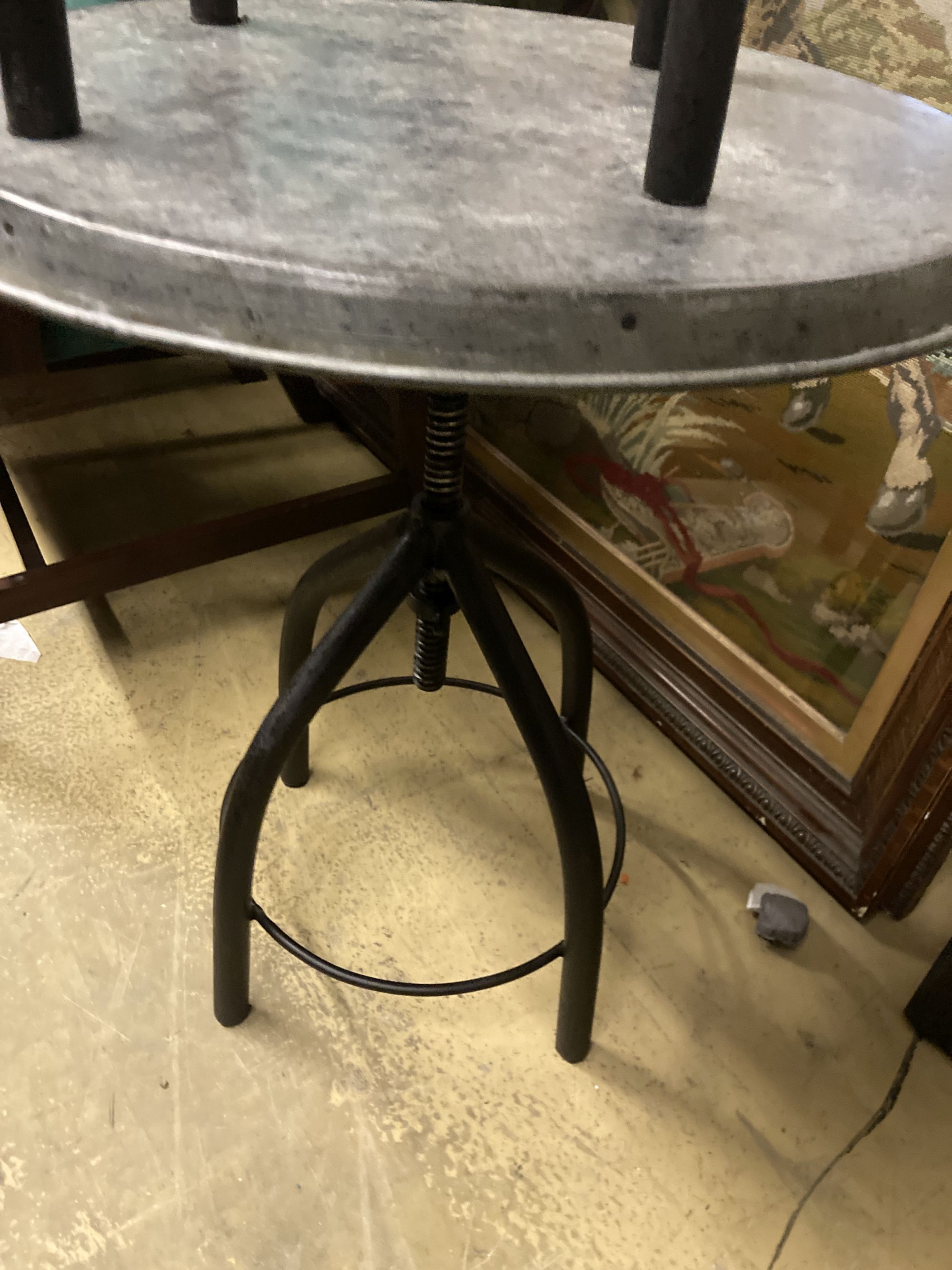 A pair of industrial style circular metal and wrought iron occasional tables, 54cm diameter, height 65cm